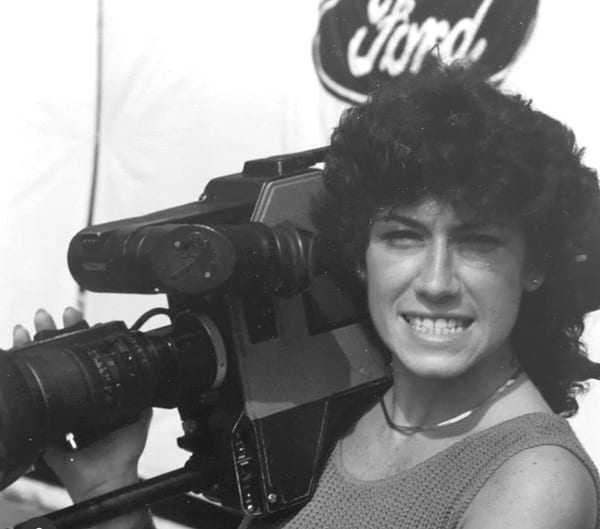 Karen Vitale holding a shoulder television camera during her earlier production career