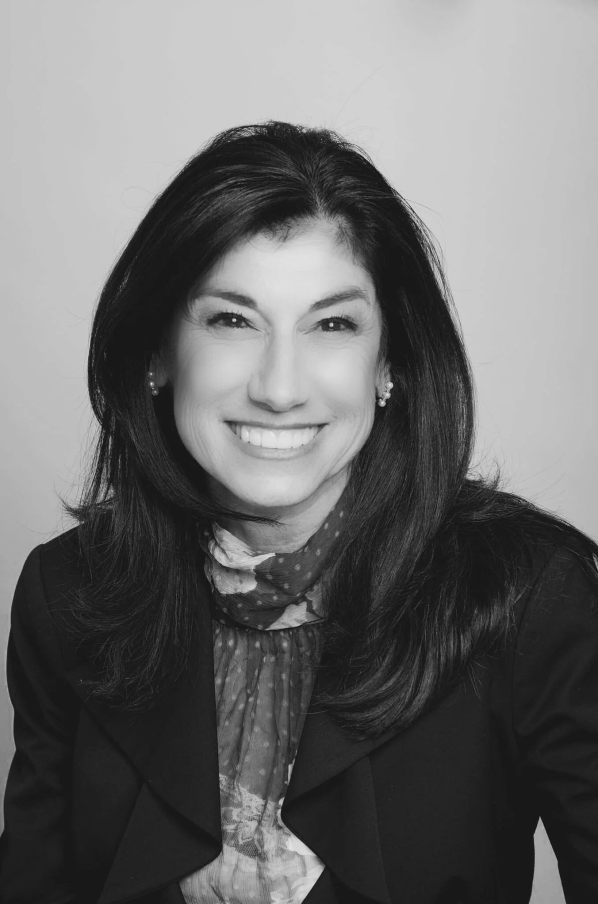 Black-and-white professional headshot of Karen Vitale, recovery coach